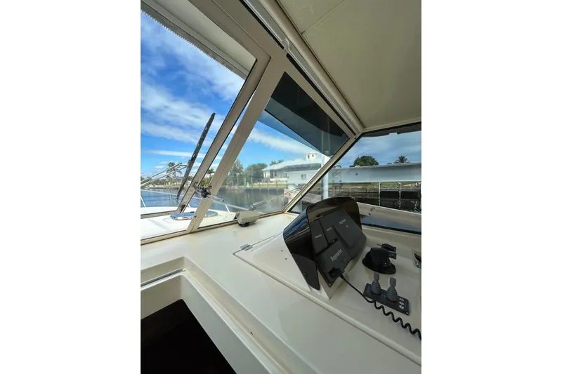 Eagle Yacht Photos Pics 2008 Mainship Pilot 34 helm view with navigation equipment and clear windshield.
