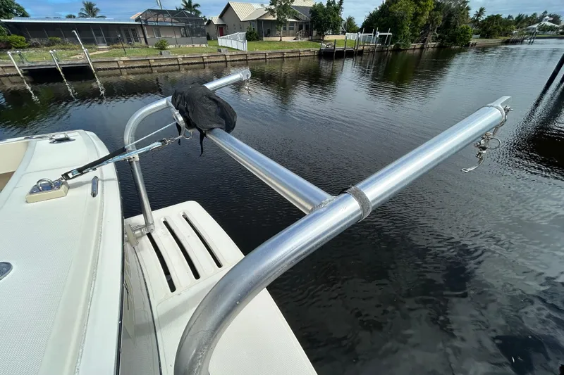 Eagle Yacht Photos Pics 2008 Mainship Pilot 34 boat with metal railing, docked by a calm waterfront.