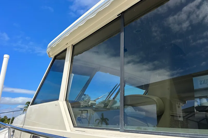 Eagle Yacht Photos Pics 2008 Mainship Pilot 34 boat with large windows under a clear blue sky.