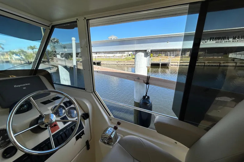Eagle Yacht Photos Pics 2008 Mainship Pilot 34 helm view with marina backdrop.