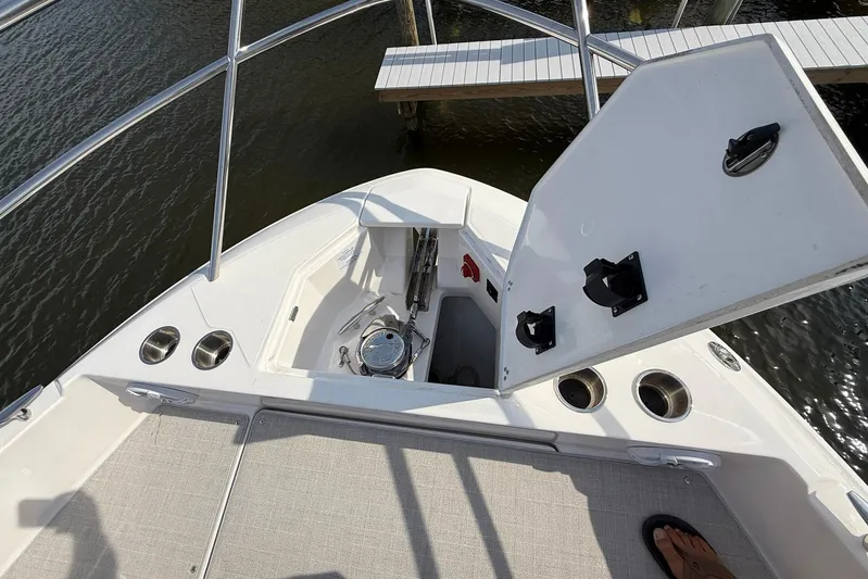 American Rebel Yacht Photos Pics Bow view of 2025 Regal 36 XO boat with open storage compartment.
