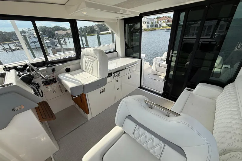 American Rebel Yacht Photos Pics Luxurious interior of 2025 Regal 36 XO yacht with plush seating and waterfront view.