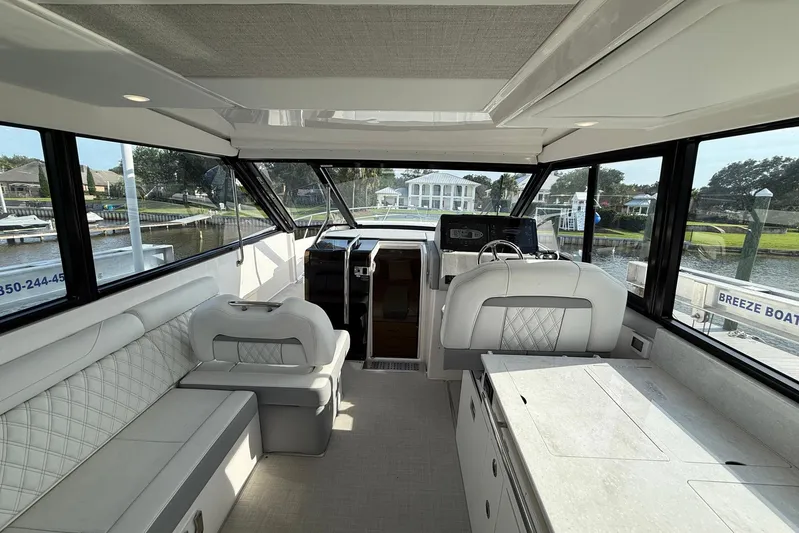 American Rebel Yacht Photos Pics Interior of 2025 Regal 36 XO yacht, featuring luxurious seating and modern helm.