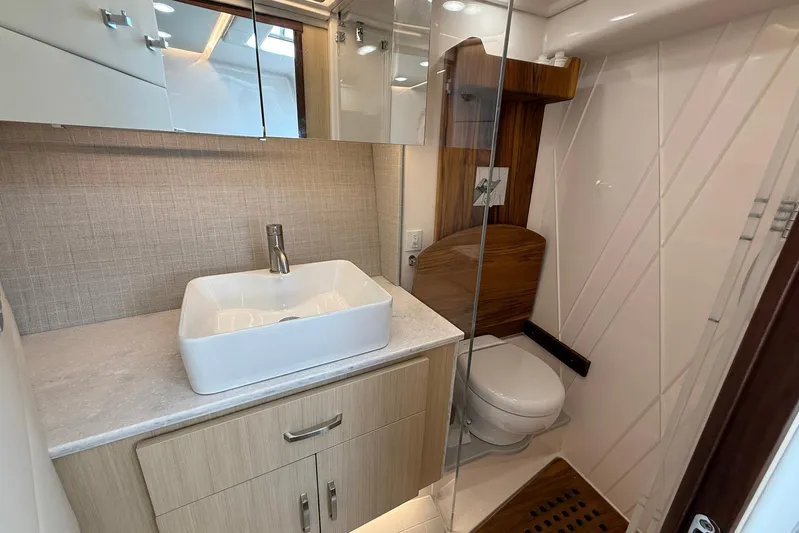 American Rebel Yacht Photos Pics Modern bathroom in 2025 Regal 36 XO yacht with sleek sink and wooden accents.