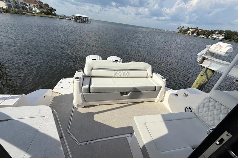 American Rebel Yacht Photos Pics 2025 Regal 36 XO boat interior with seating, overlooking serene waterfront view.