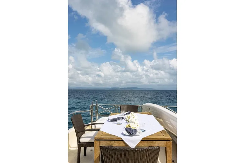 Seabear Yacht Photos Pics Luxury dining setup on Amanda 72 Explorer yacht, 2006, with ocean view.