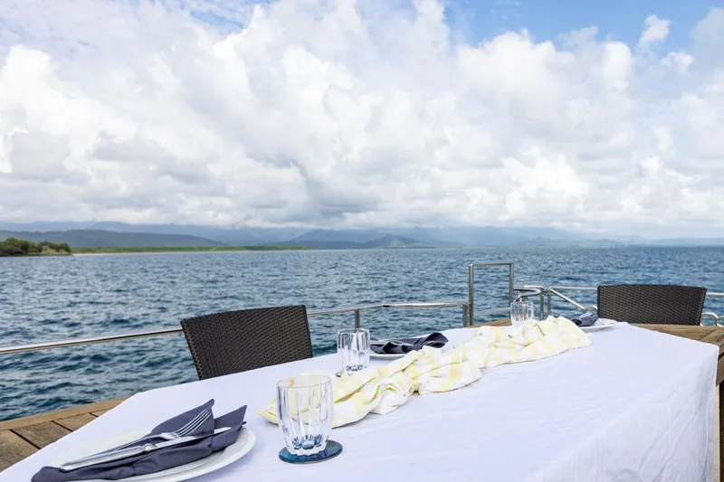 Seabear Yacht Photos Pics Outdoor dining setup on a yacht with ocean view, Amanda 72 Explorer, 2006.