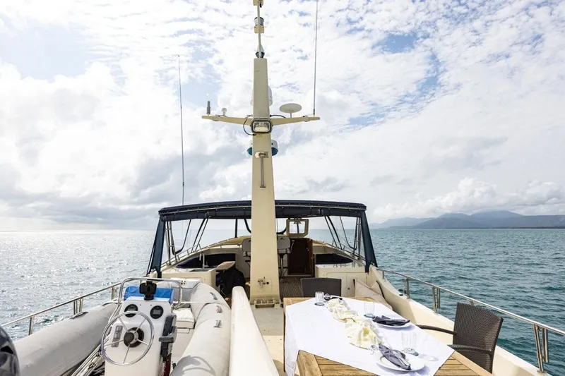 Seabear Yacht Photos Pics Luxurious Amanda 72 Explorer yacht deck with dining setup, 2006 model, cruising on serene waters.