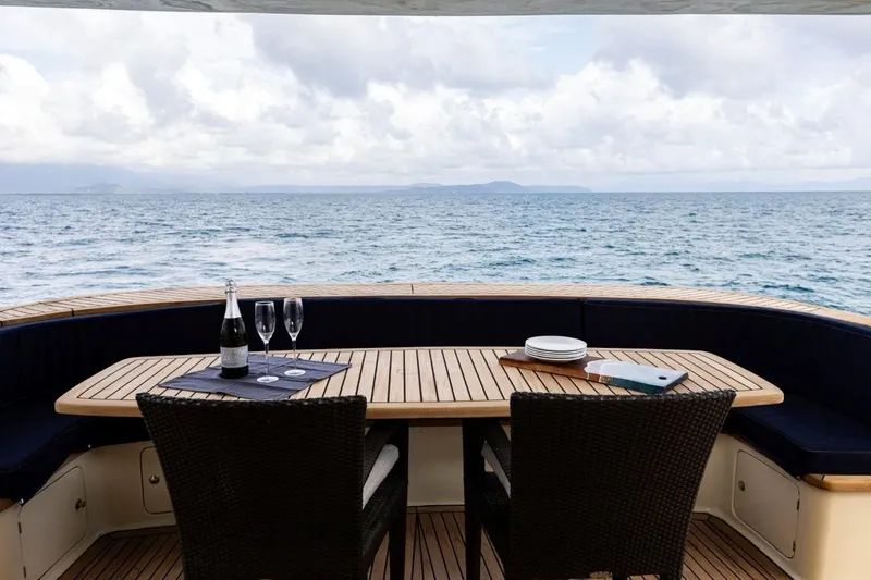 Seabear Yacht Photos Pics Luxury yacht deck with dining setup, ocean view; Amanda 72 Explorer, 2006 model.