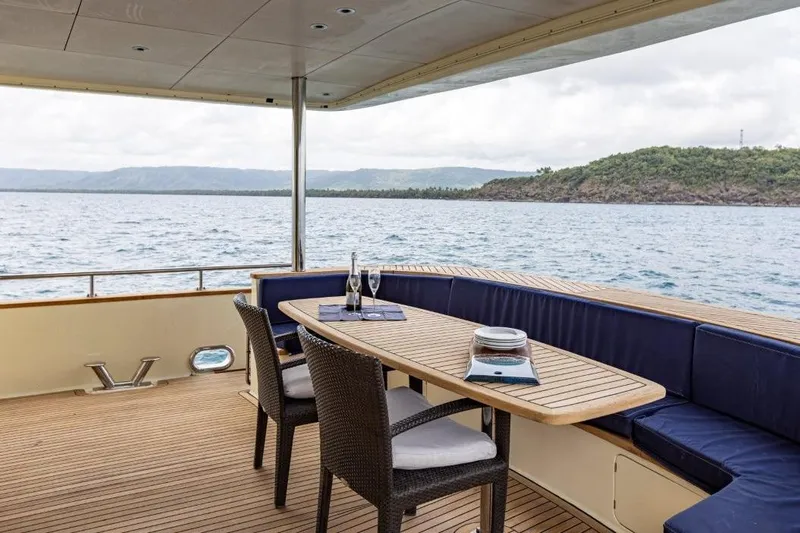 Seabear Yacht Photos Pics Luxury yacht deck with ocean view, featuring elegant seating and dining area. Amanda 72 Explorer, 2006.