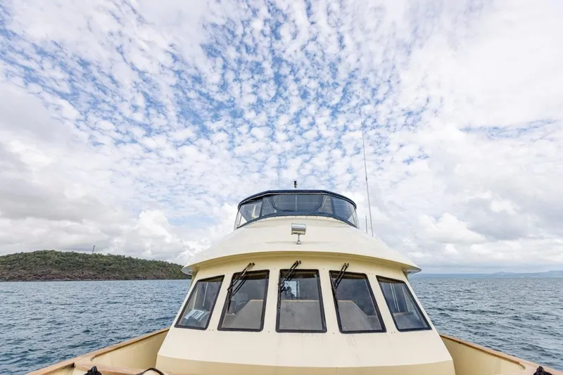 Seabear Yacht Photos Pics Front view of 2006 Amanda 72 Explorer boat under a cloudy sky.