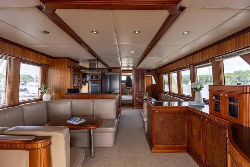 Seabear Yacht Photos Pics Luxurious interior of 2006 Amanda 72 Explorer yacht with elegant wood finishes and comfortable seating.