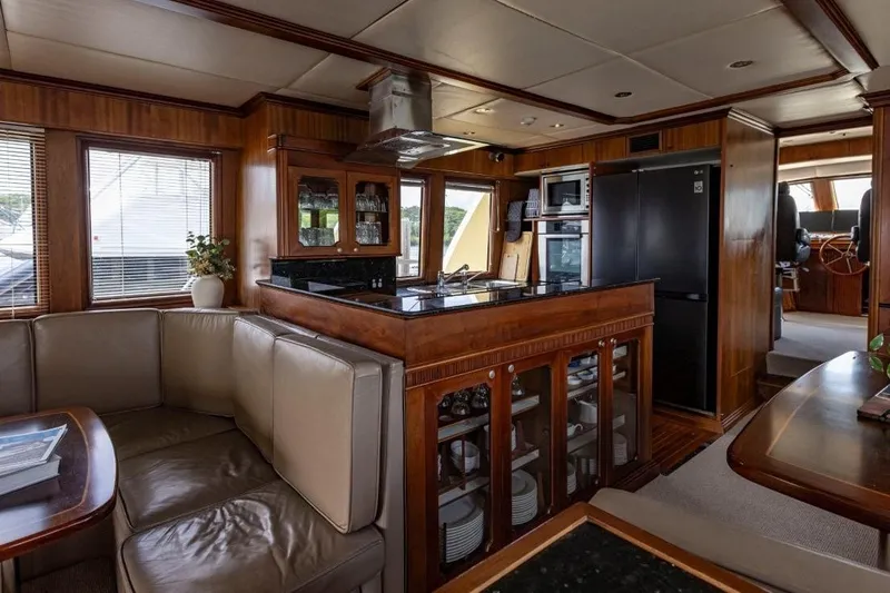 Seabear Yacht Photos Pics Luxurious interior of 2006 Amanda 72 Explorer yacht with modern kitchen and seating area.