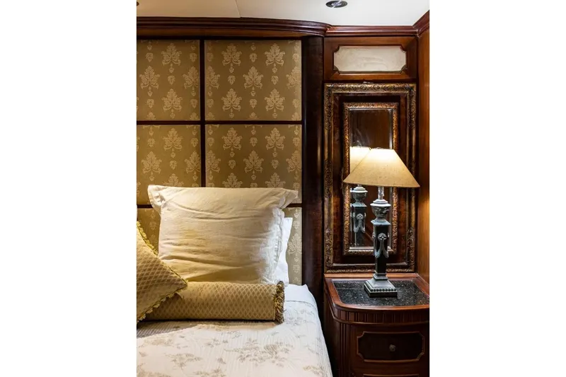 Seabear Yacht Photos Pics Luxurious bedroom interior with elegant lamp and ornate wooden paneling, Amanda 72 Explorer 2006.