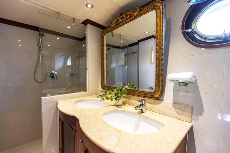 Seabear Yacht Photos Pics Luxurious yacht bathroom with double sinks, ornate mirror, and glass shower in 2006 Amanda 72 Explorer.