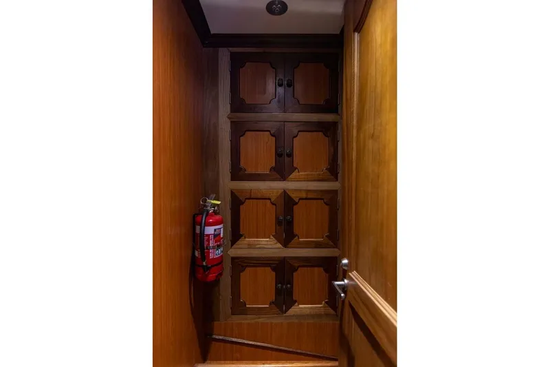 Seabear Yacht Photos Pics Wooden cabinets and fire extinguisher in Amanda 72 Explorer, 2006 model interior.