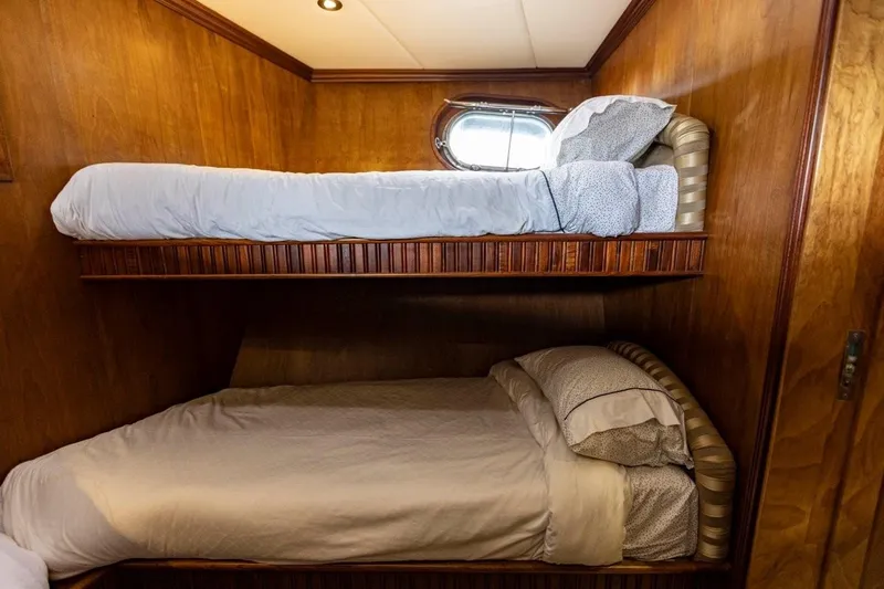 Seabear Yacht Photos Pics Bunk beds in a 2006 Amanda 72 Explorer yacht cabin with wooden interior.