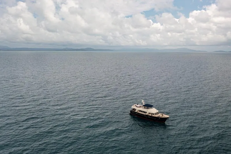 Seabear Yacht Photos Pics A 2006 Amanda 72 Explorer yacht on a vast, calm ocean under cloudy skies.