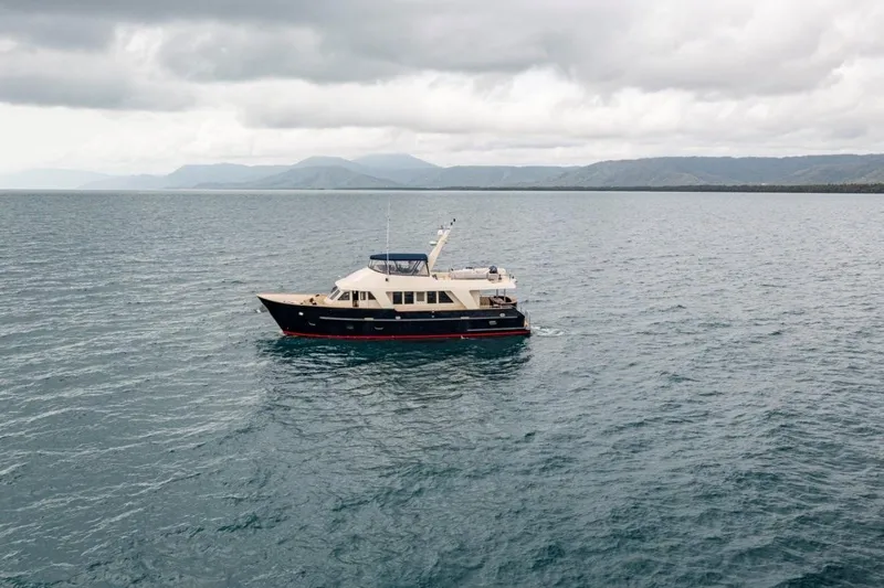 Seabear Yacht Photos Pics Luxury yacht Amanda 72 Explorer, 2006 model, cruising on open sea under cloudy skies.
