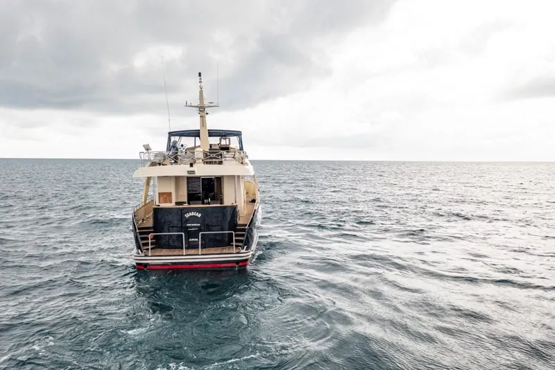 Seabear Yacht Photos Pics Luxury yacht Amanda 72 Explorer 2006 on open sea under cloudy sky.