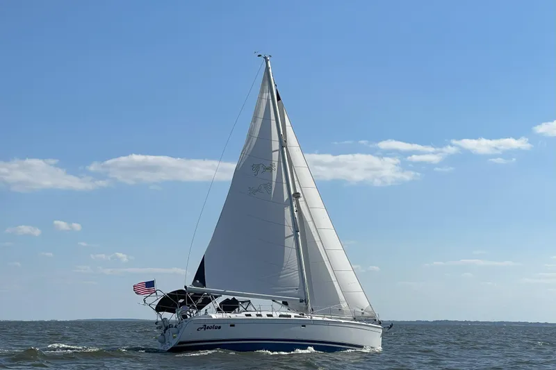 Aeolus Yacht Photos Pics Sailing yacht Hunter 49 (2007) on open water under clear blue sky.