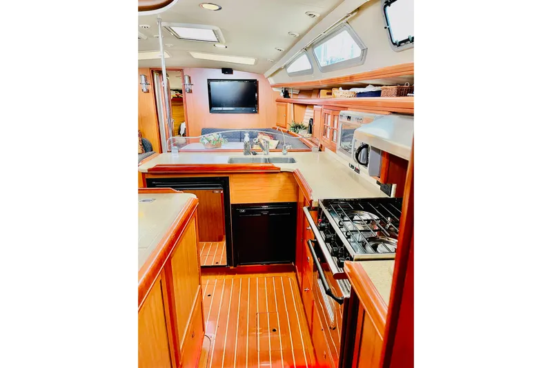 Aeolus Yacht Photos Pics Luxurious interior of 2007 Hunter 49 yacht with modern kitchen and wooden flooring.