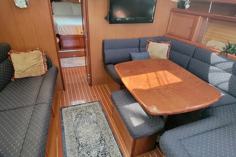 Aeolus Yacht Photos Pics Luxurious 2007 Hunter 49 yacht interior with cozy seating and elegant wooden table.