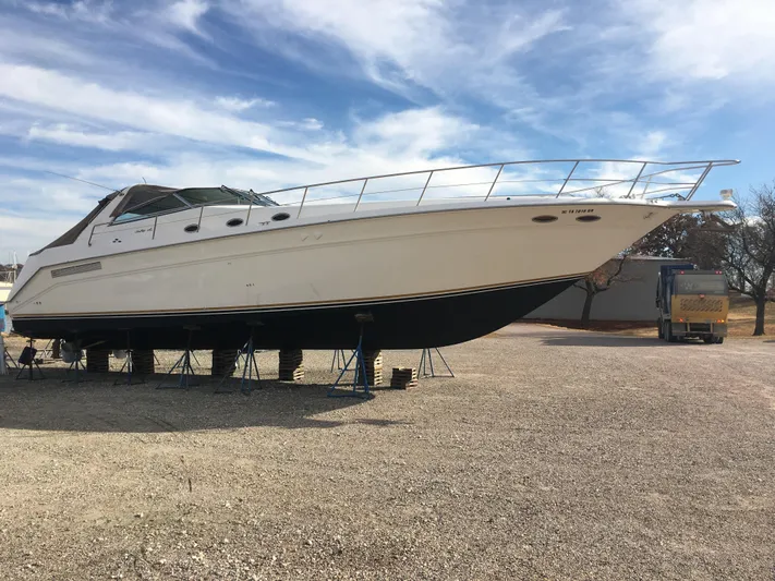  Yacht Photos Pics 1994 Sea Ray 500 Sundancer yacht on stands, under a partly cloudy sky.