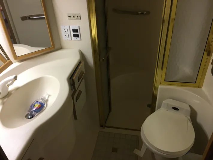  Yacht Photos Pics Bathroom interior of 1994 Sea Ray 500 Sundancer yacht, featuring sink, toilet, and shower.