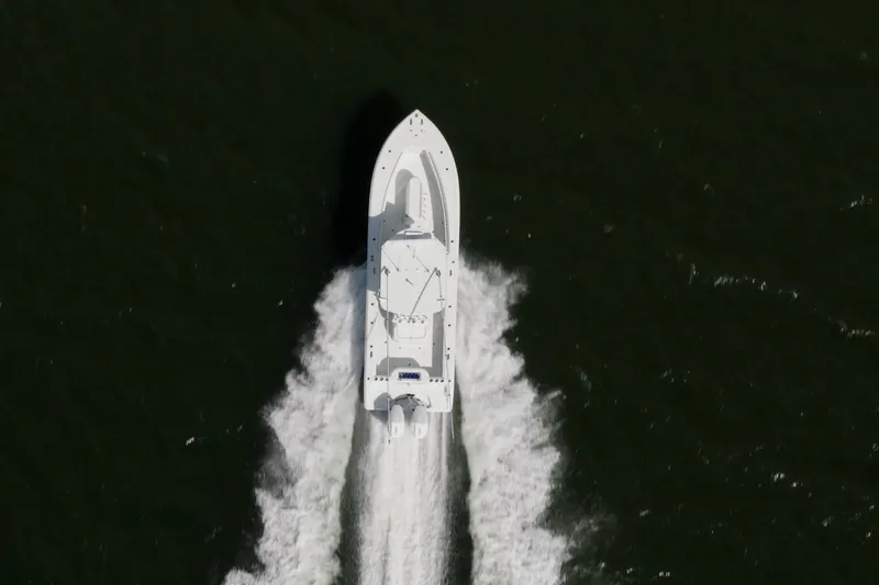 Done Deal Yacht Photos Pics Aerial view of 2014 Yellowfin 32 Offshore boat speeding on water.