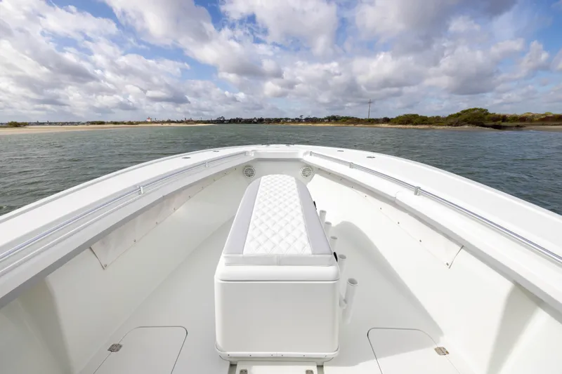 Done Deal Yacht Photos Pics 2014 Yellowfin 32 Offshore boat on calm waters under a cloudy sky.