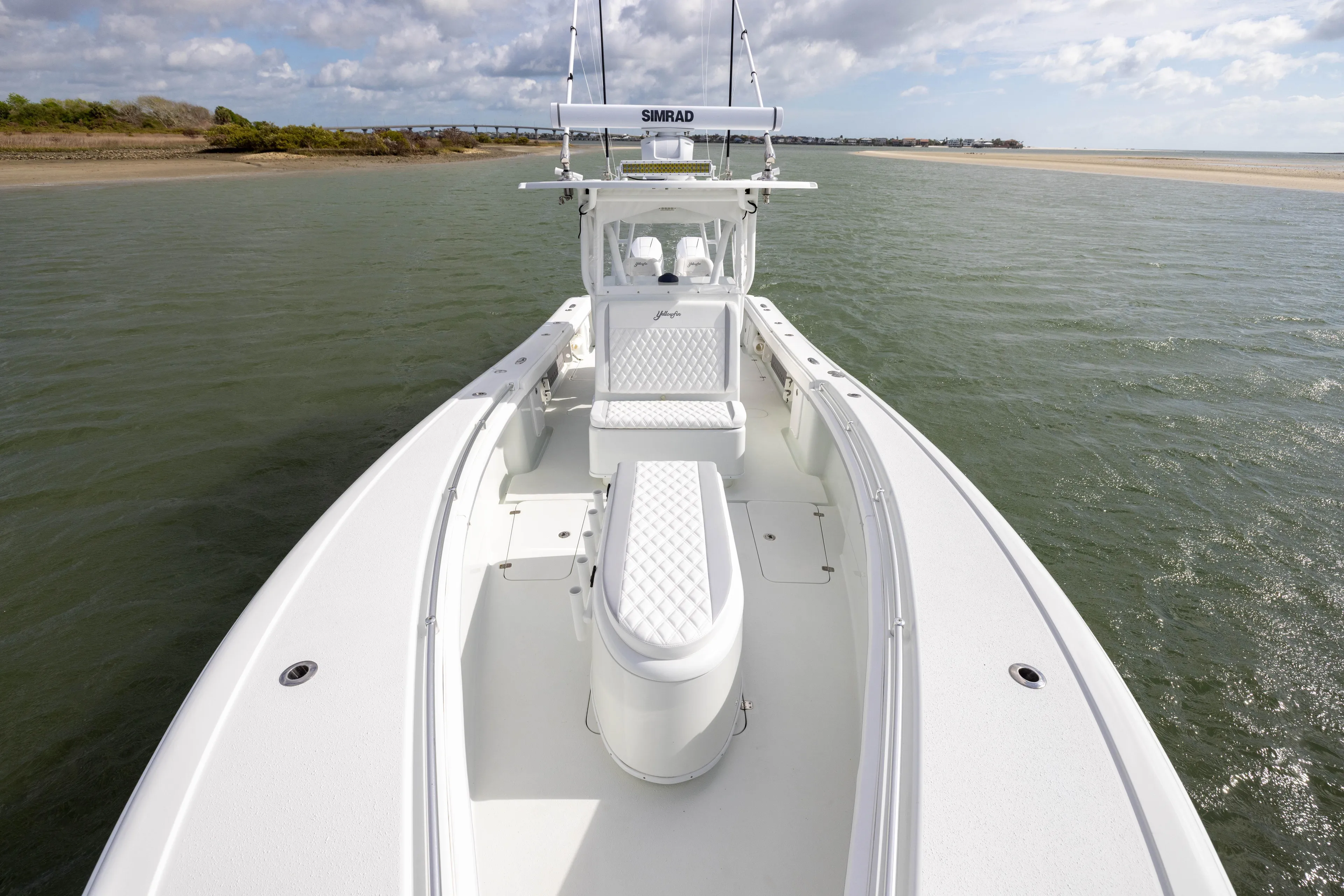 Done Deal Yacht Photos Pics 2014 Yellowfin 32 Offshore boat on calm water, featuring spacious deck and seating.