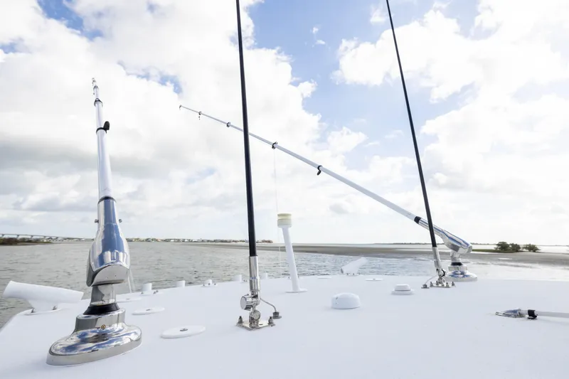 Done Deal Yacht Photos Pics 2014 Yellowfin 32 Offshore boat with fishing rods, under a partly cloudy sky.