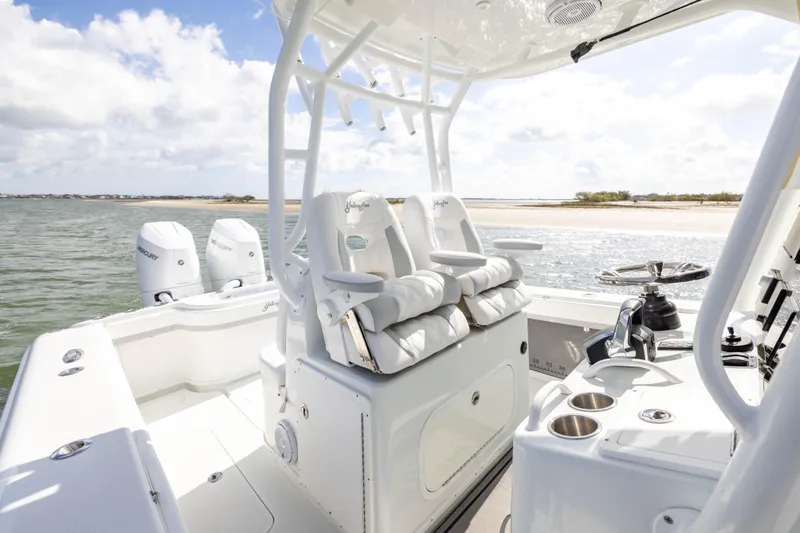 Done Deal Yacht Photos Pics 2014 Yellowfin 32 Offshore boat interior with dual Mercury engines, near sandy shoreline.