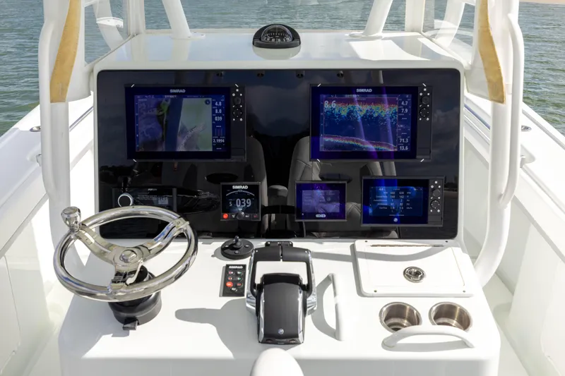 Done Deal Yacht Photos Pics 2014 Yellowfin 32 Offshore boat dashboard with advanced navigation displays and controls.