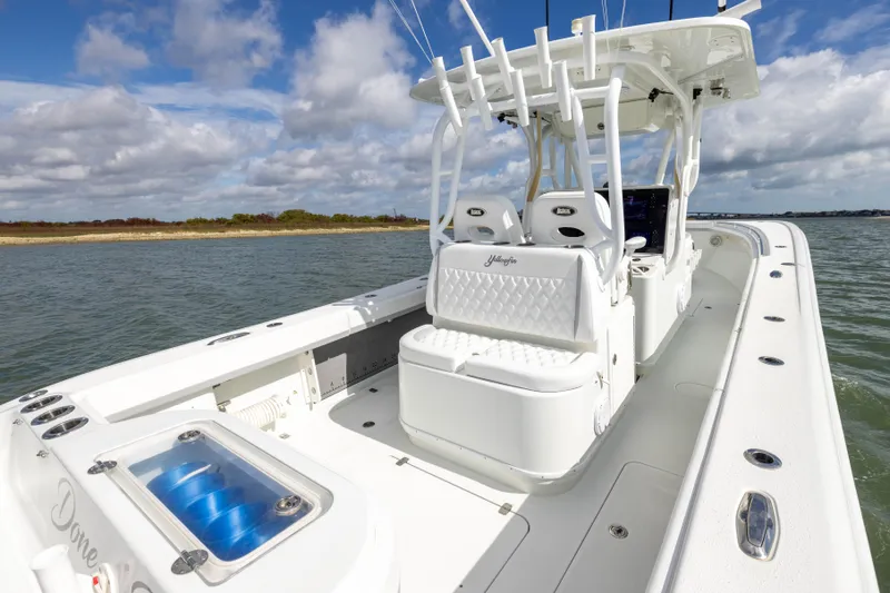 Done Deal Yacht Photos Pics 2014 Yellowfin 32 Offshore boat on water, featuring spacious deck and seating.