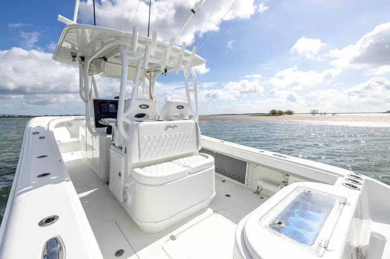 Done Deal Yacht Photos Pics 2014 Yellowfin 32 Offshore boat on calm waters under a sunny sky.