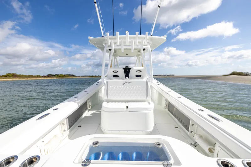 Done Deal Yacht Photos Pics 2014 Yellowfin 32 Offshore boat on calm waters under a blue sky.