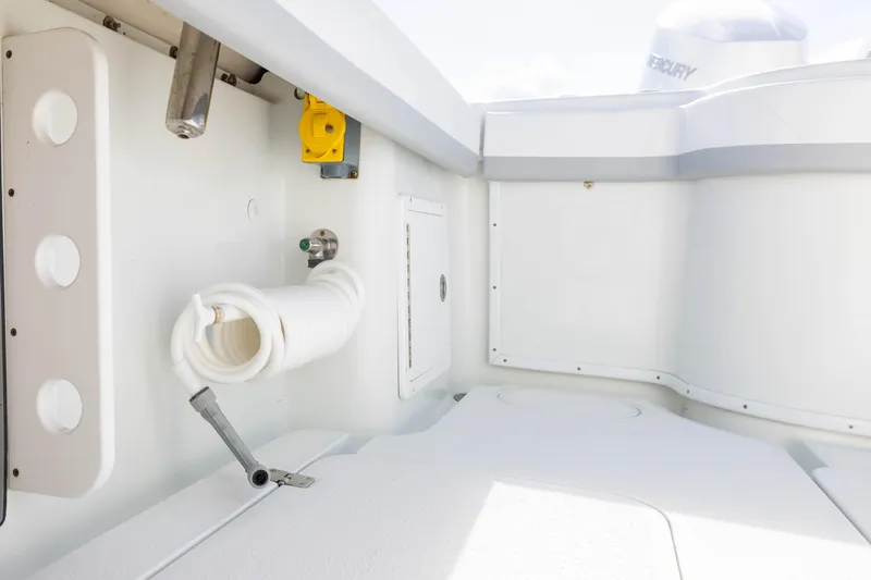 Done Deal Yacht Photos Pics 2014 Yellowfin 32 Offshore boat interior with hose and storage compartments.