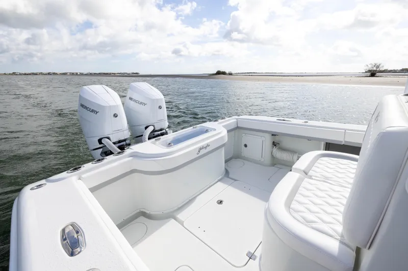 Done Deal Yacht Photos Pics 2014 Yellowfin 32 Offshore boat with twin Mercury engines on calm water.