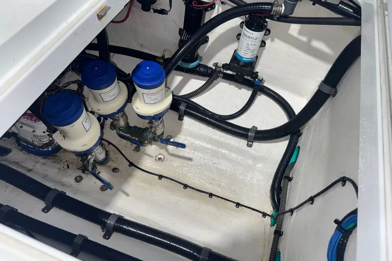 Done Deal Yacht Photos Pics 2014 Yellowfin 32 Offshore boat engine compartment with pumps and hoses.