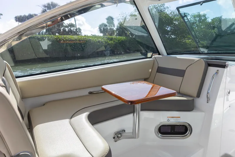 Joysea Yacht Photos Pics 2019 Pursuit DC 325 Dual Console interior with seating and wooden table.