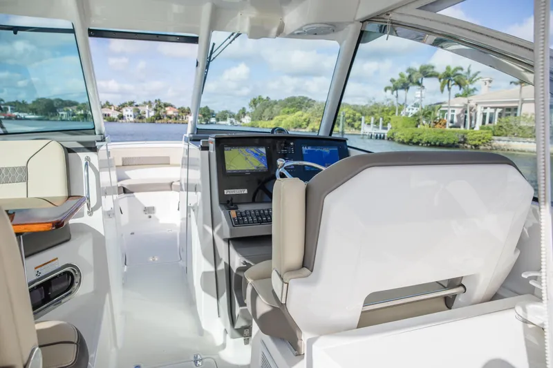 Joysea Yacht Photos Pics 2019 Pursuit DC 325 Dual Console boat interior with helm and navigation screens.