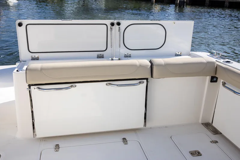 Joysea Yacht Photos Pics 2019 Pursuit DC 325 Dual Console boat interior with cushioned seating and storage compartments.