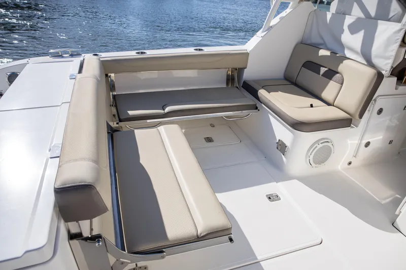Joysea Yacht Photos Pics 2019 Pursuit DC 325 Dual Console boat interior with beige seating and water view.