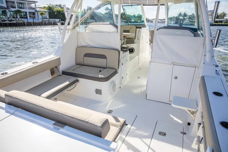 Joysea Yacht Photos Pics 2019 Pursuit DC 325 Dual Console boat interior with seating and water view.