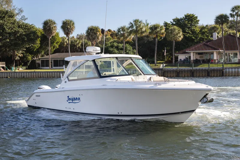 Joysea Yacht Photos Pics 2019 Pursuit DC 325 Dual Console boat cruising on a scenic waterway.