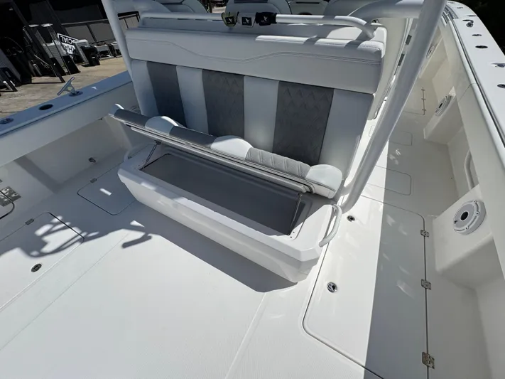  Yacht Photos Pics 2022 Invincible 46 Catamaran with open storage compartment and sleek seating design.