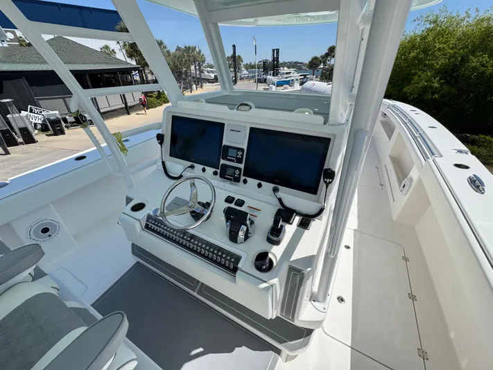  Yacht Photos Pics Invincible 46 Catamaran 2022 helm with dual screens and controls, dockside view.