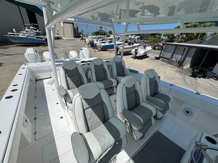  Yacht Photos Pics 2022 Invincible 46 Catamaran with luxurious seating, docked at a marina.